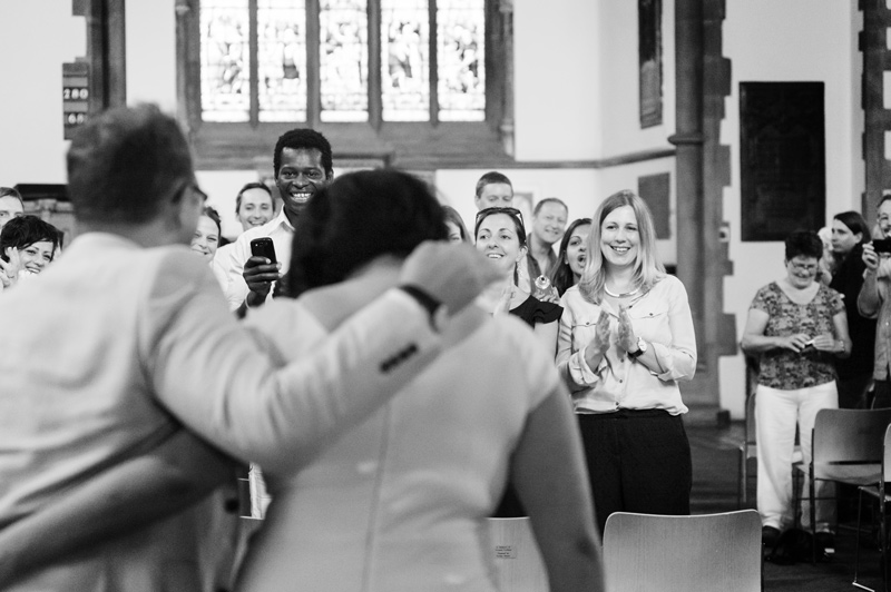 Bride and groom walking into Rosslyn Hill Chapel by London reportage wedding photographer James Robertshaw