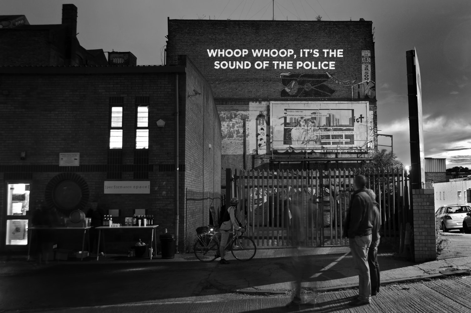 Song lyrics projected on the side of a building photographed by James Robertshaw