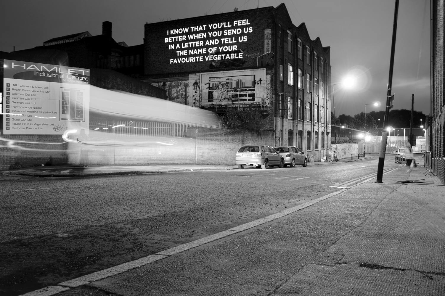 Song lyrics projected on the side of a building photographed by James Robertshaw