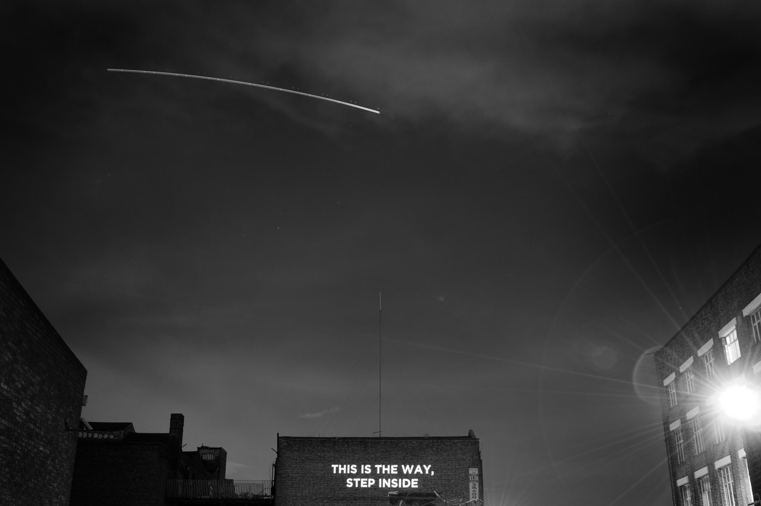 Song lyrics projected on the side of a building photographed by James Robertshaw