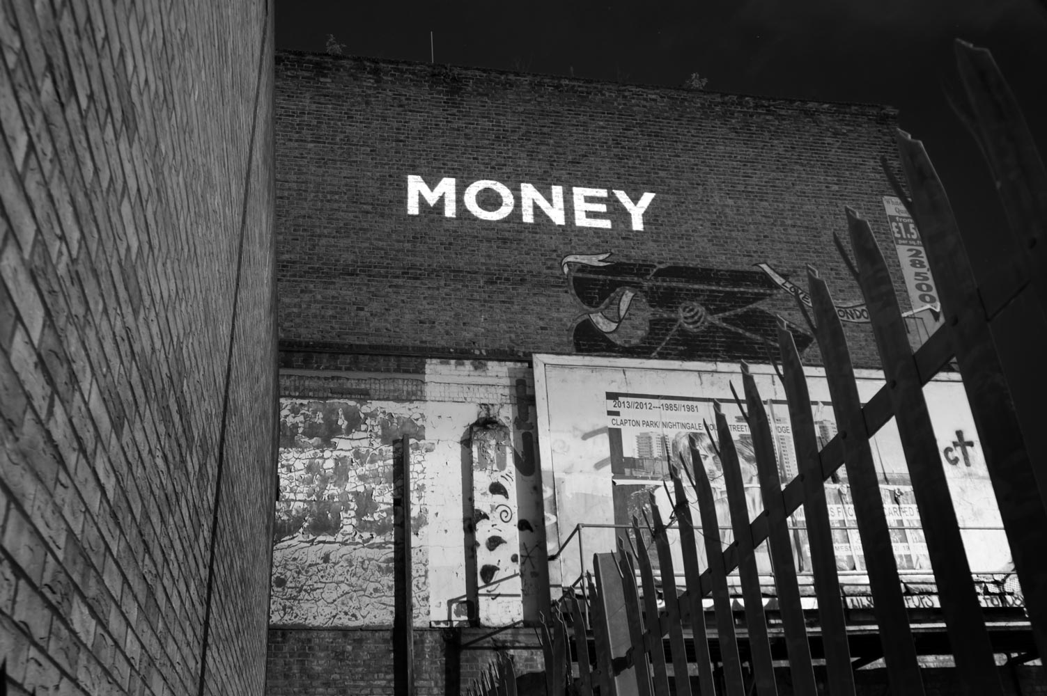 "Money" - Song lyrics projected on the side of a building photographed by James Robertshaw