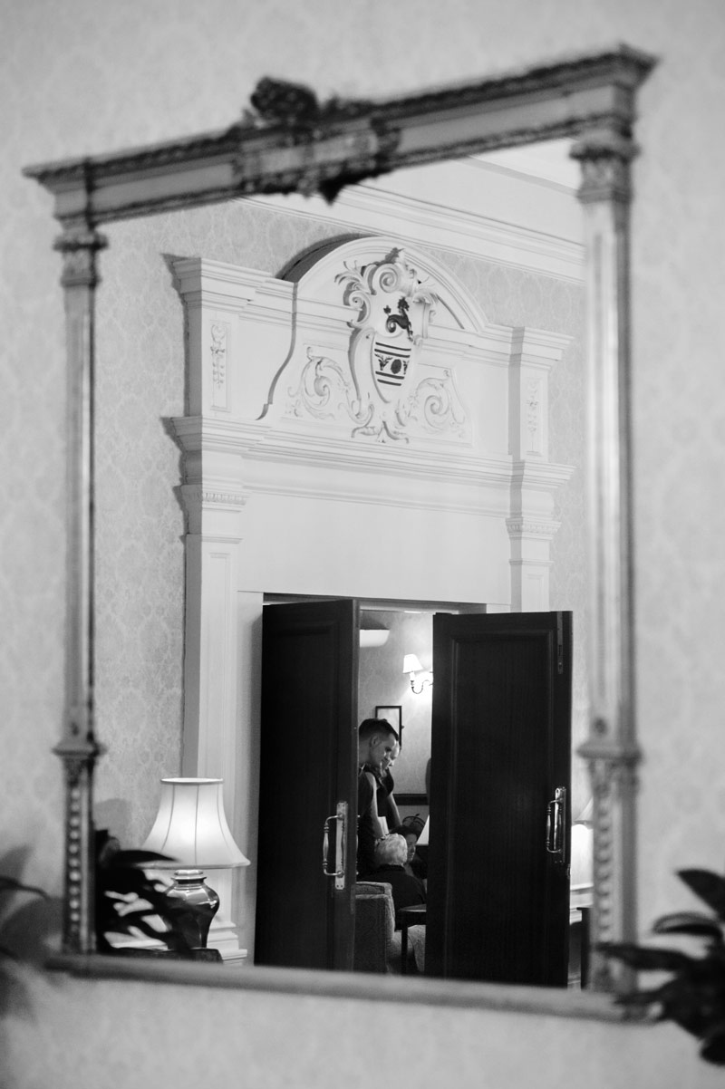 Wedding guests in mirror at The Grand Eastbourne by Sussex wedding photographer James Robertshaw
