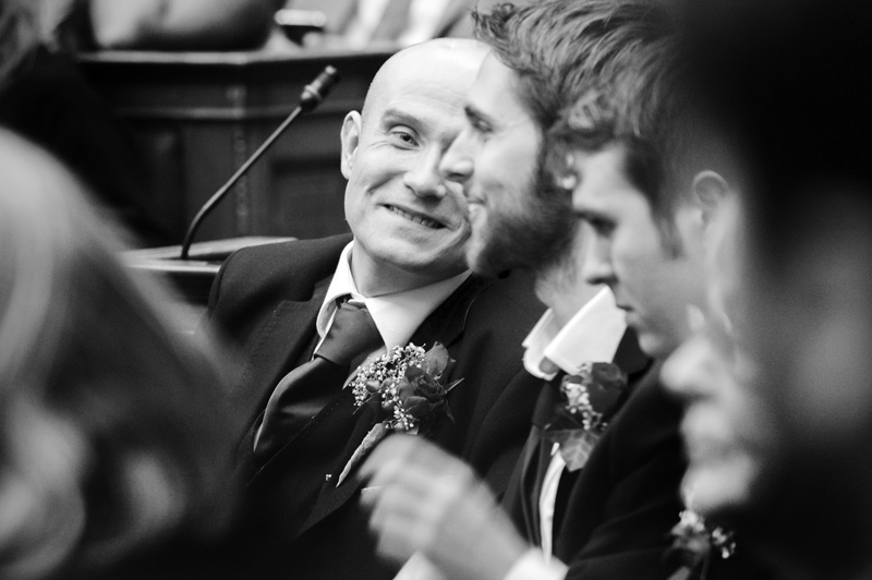 Groom smiling at best man at Camden Town Hall wedding