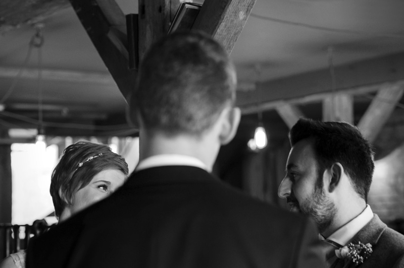 Bride and Groom glance at the Bell Ticehurst wedding by Sussex Wedding photographer James Robertshaw
