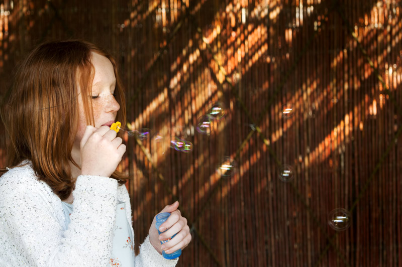 Girl blowing bubbles at The Walled Garden Cowdray wedding reception