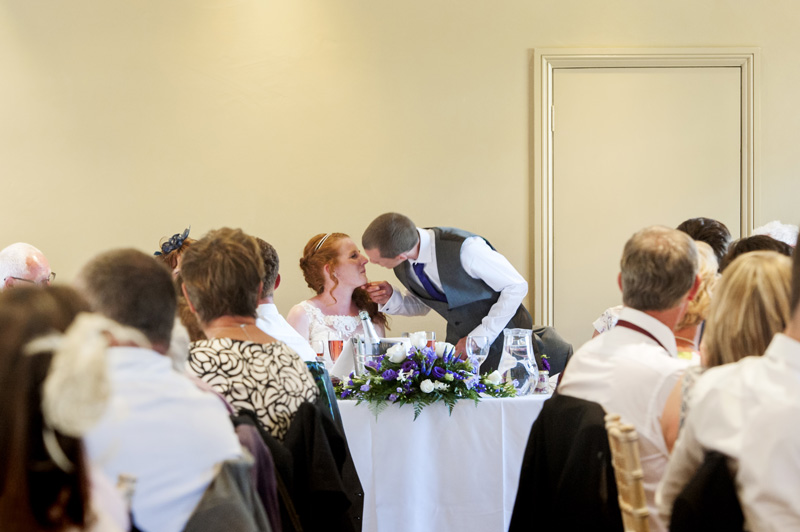 Bride and groom kiss at Walled Garden Cowdray wedding reception