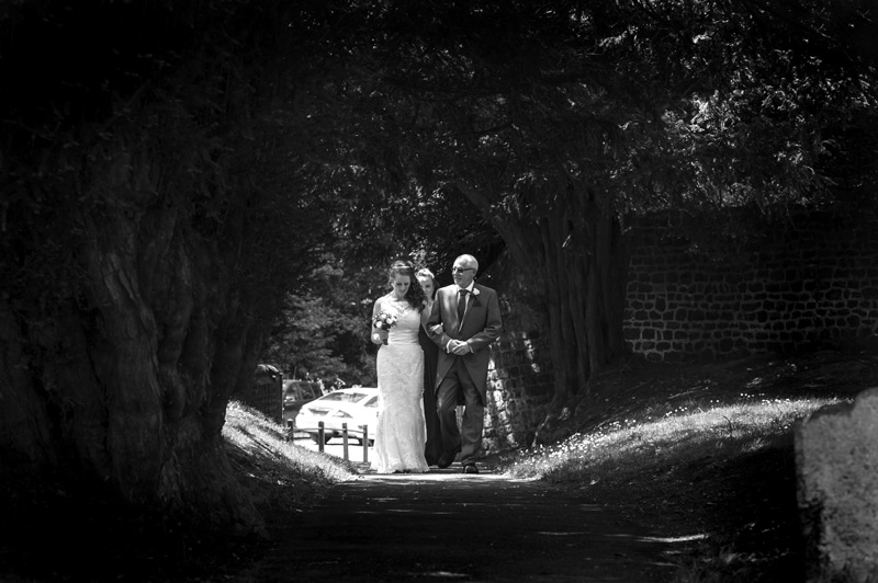 Bride and father arriving at St James Church Stedham
