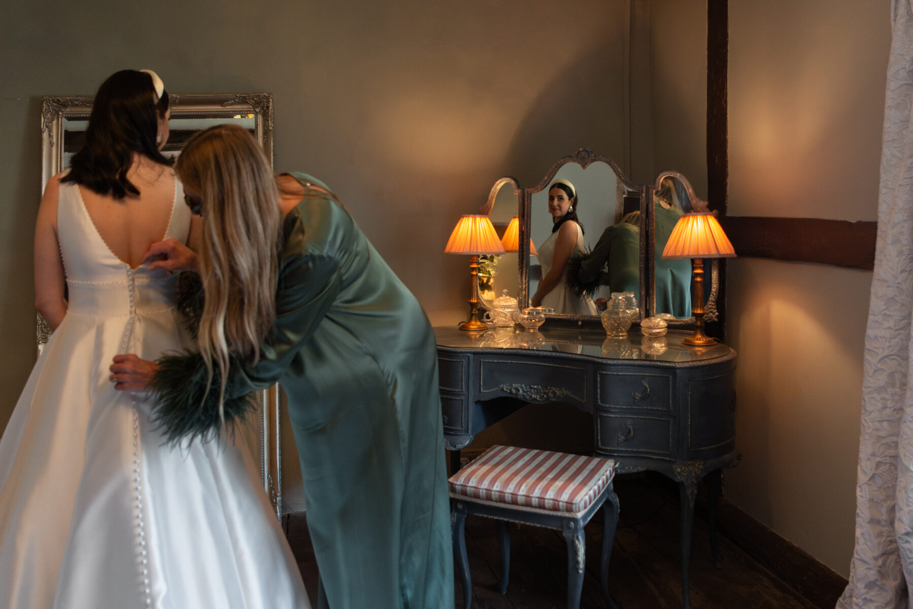 Bride's mother adjusting bride's dress at the Pilrgim's Rest