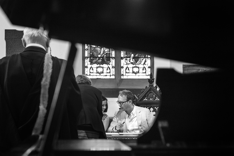 Couple signing register at Rosslyn Hill Chapel by London reportage wedding photographer James Robertshaw