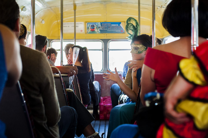 Guests in fancy dress on wedding bus