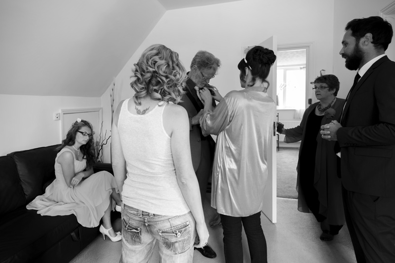 Bride fixing Dad's buttonhole at Leeford place wedding by Sussex wedding photographer James Robertshaw