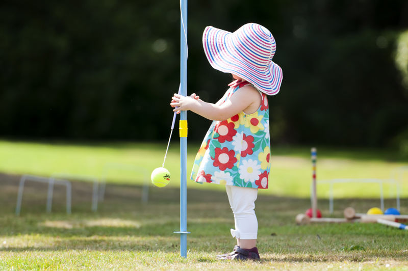 Child with swing ball at Leeford place by Sussex wedding photographer James Robertshaw