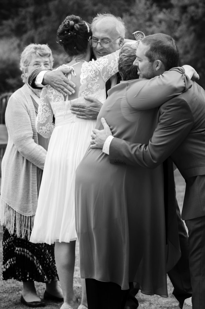 Couple hugging parents at Leeford place by Sussex wedding photographer James Robertshaw