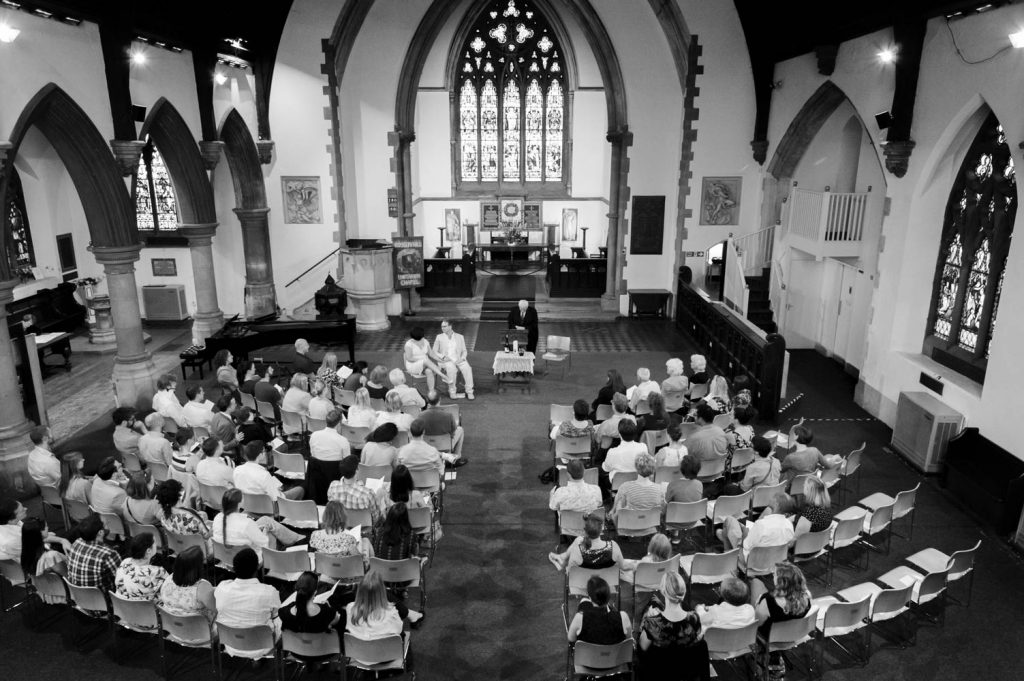 Wedding congregation from above at Rosslyn Hill by London reportage wedding photographer James Robertshaw