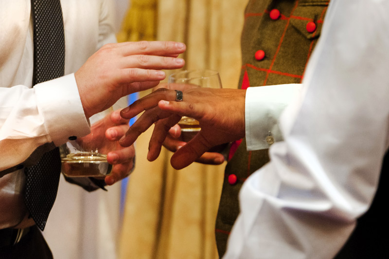 Looking at groom's wedding ring at The Grand Hotel Eastbourne by Sussex wedding photographer James Robertshaw