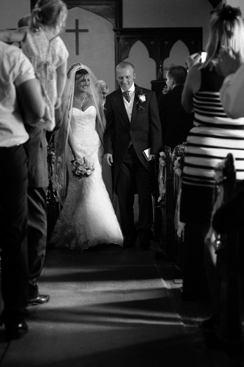 just married couple walking out of church