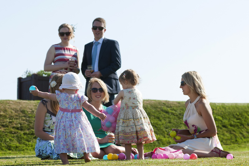 Wedding guests on lawn at Cooden Beach Hotel wedding reception by Sussex wedding photographer James Robertshaw