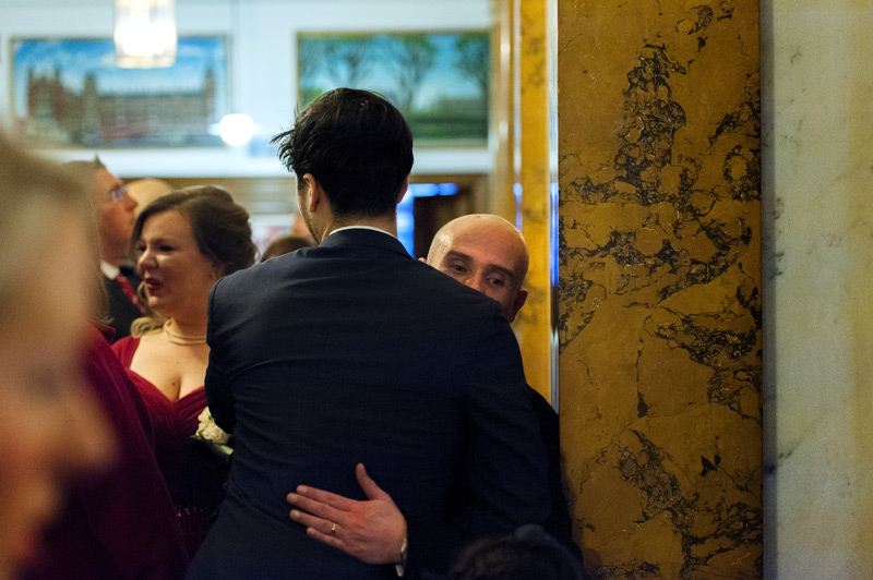 Groom hugging friend after Camden Town Hall wedding