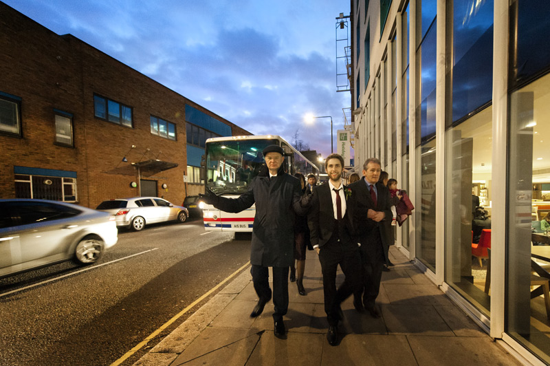 Wedding guests walking down London street