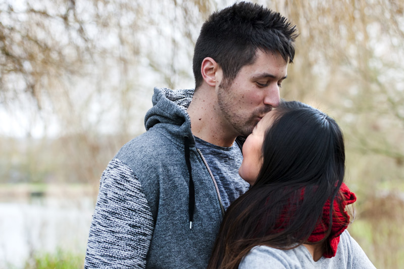 Man kissing fiancé forehead - natural couple photography by James Robertshaw