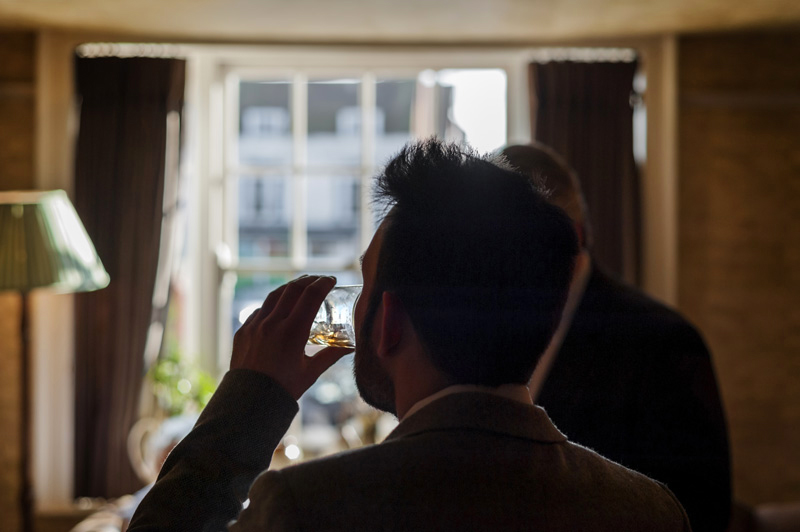 Groom having a drink at the Bell Ticehurst wedding by Sussex Wedding photographer James Robertshaw