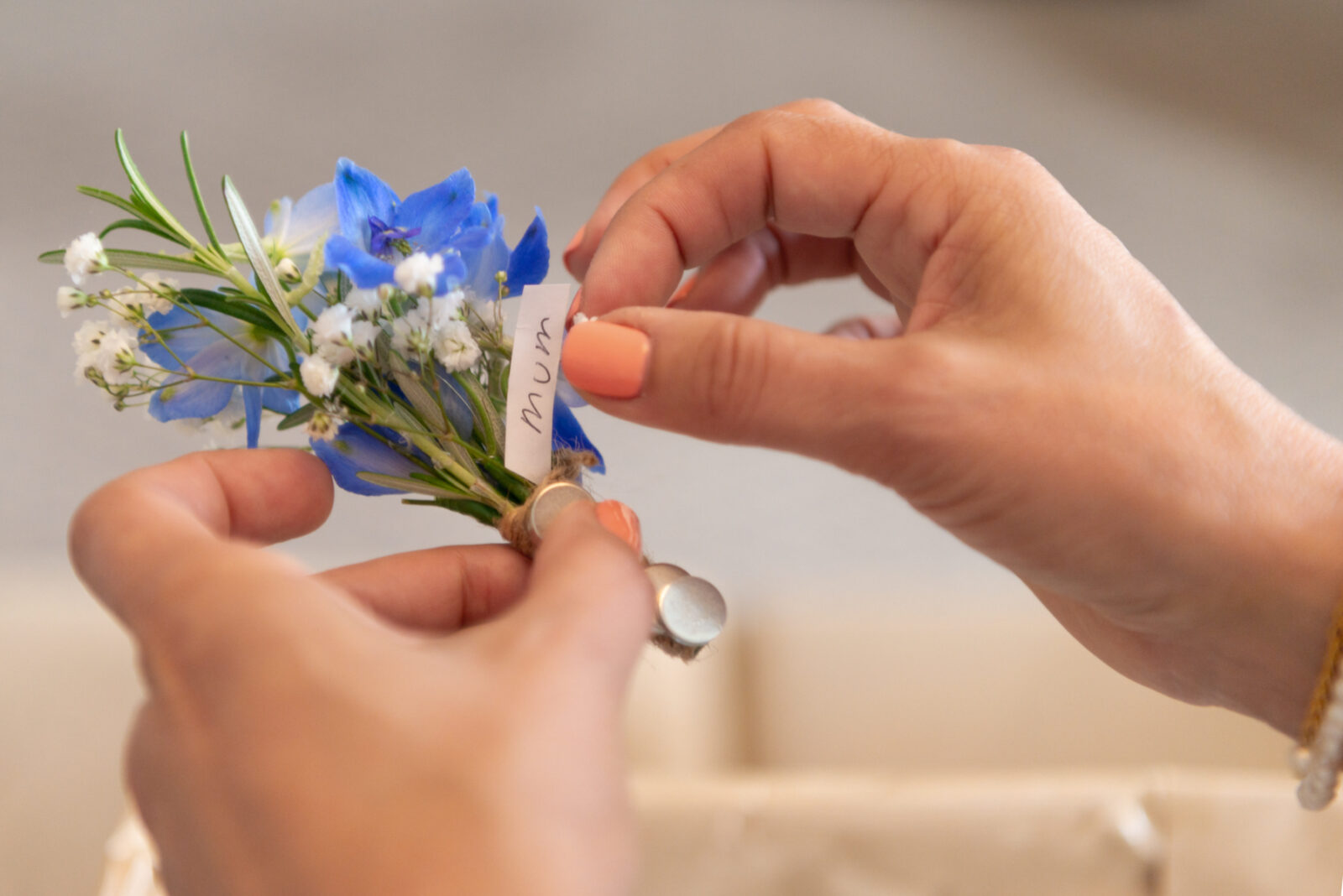 Bride holding her mum's buttonhole