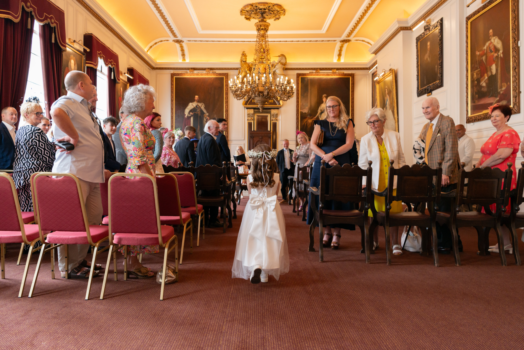 Bridesmaid walking down the isle at Windsor Guildhall wedding by Windsor Guildhall wedding photographer James Robertshaw 