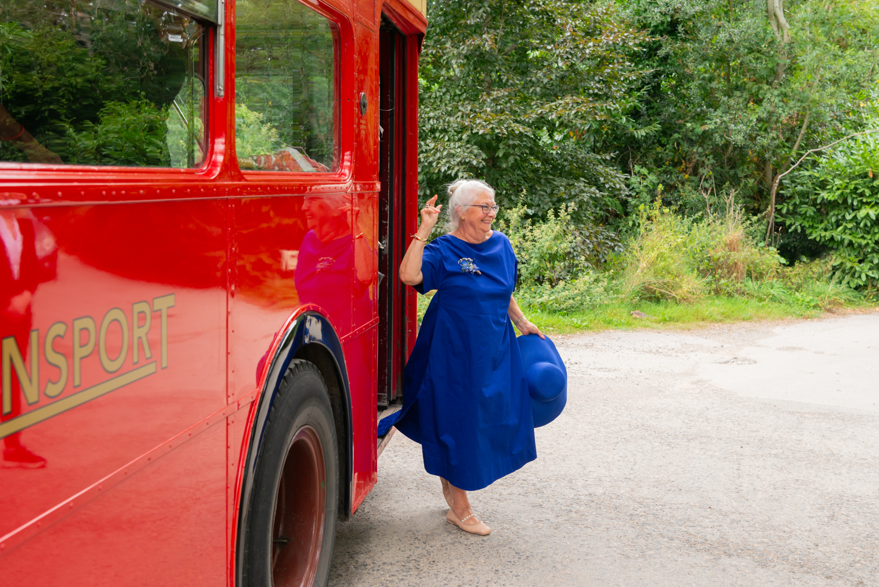 Mother of the bride stepping off bus at Dorney Court by Windsor Guildhall wedding photographer James Robertshaw
