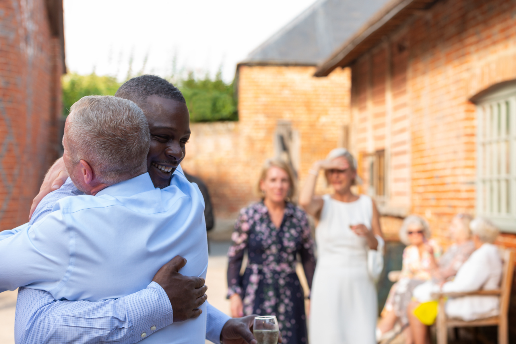 Groom embracing guest at Dourney Court