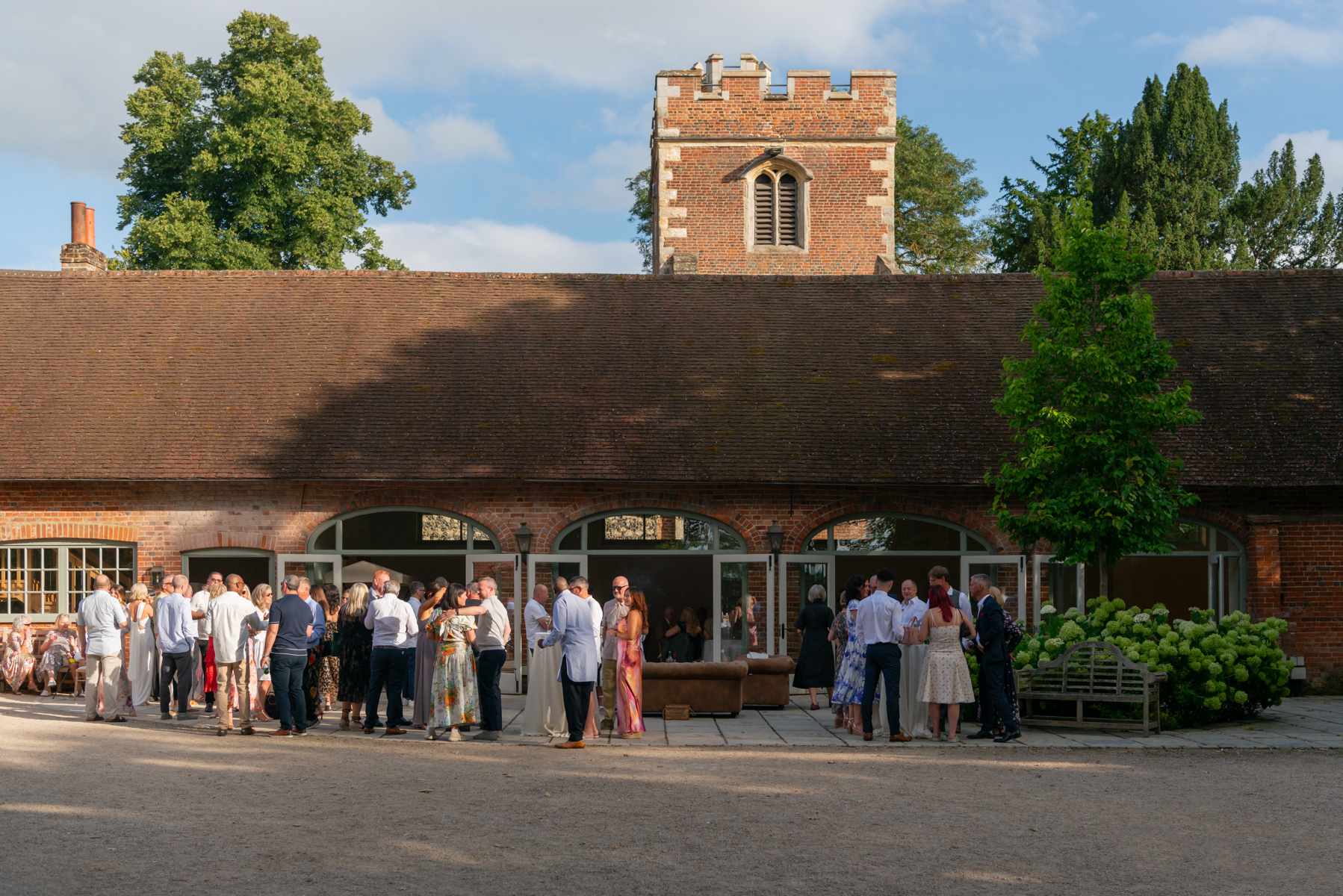 Wedding guests in the grounds of Dourney Court