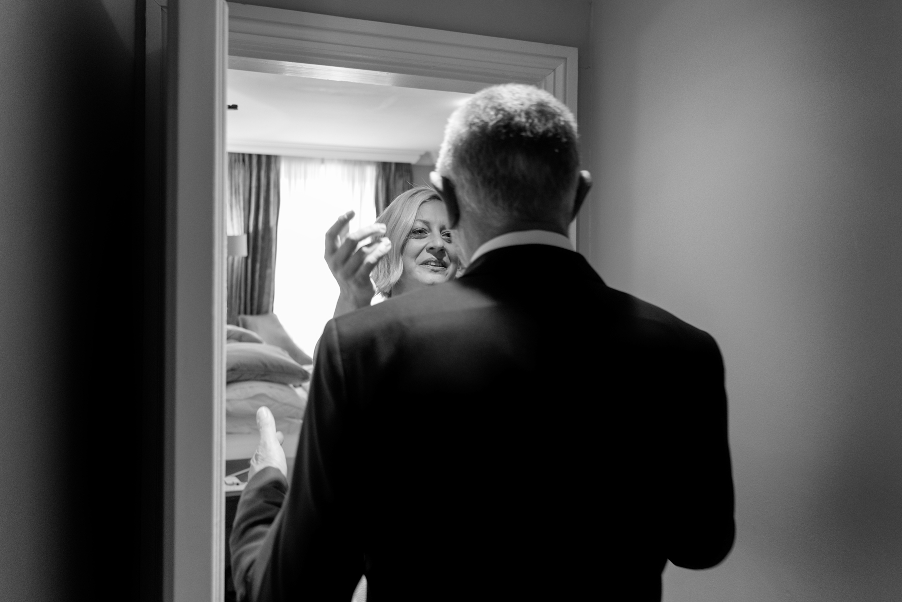 Bride greeting father in hotel room